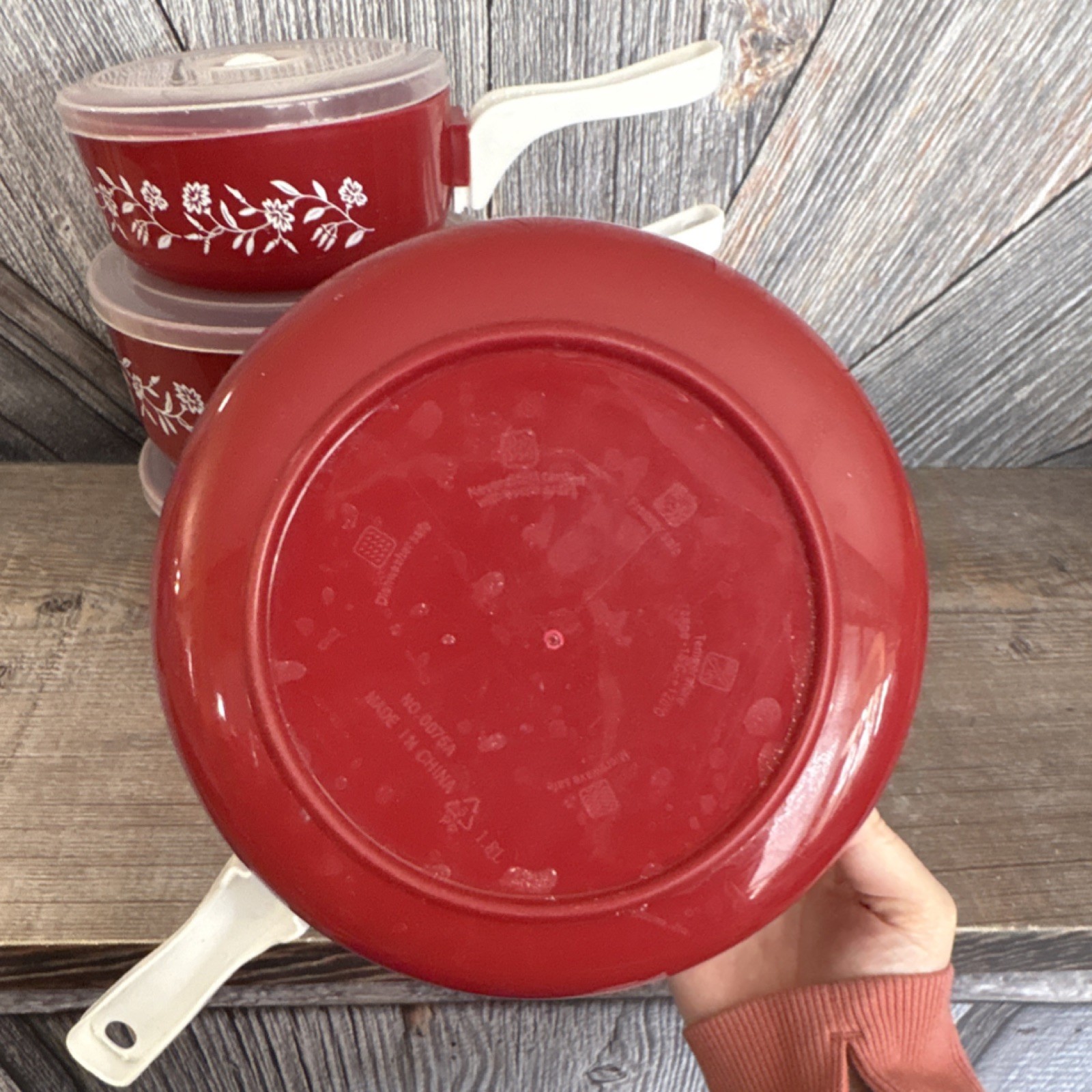 Red Floral Plastic Four-Piece Saucepan Set with Lids and White Handles