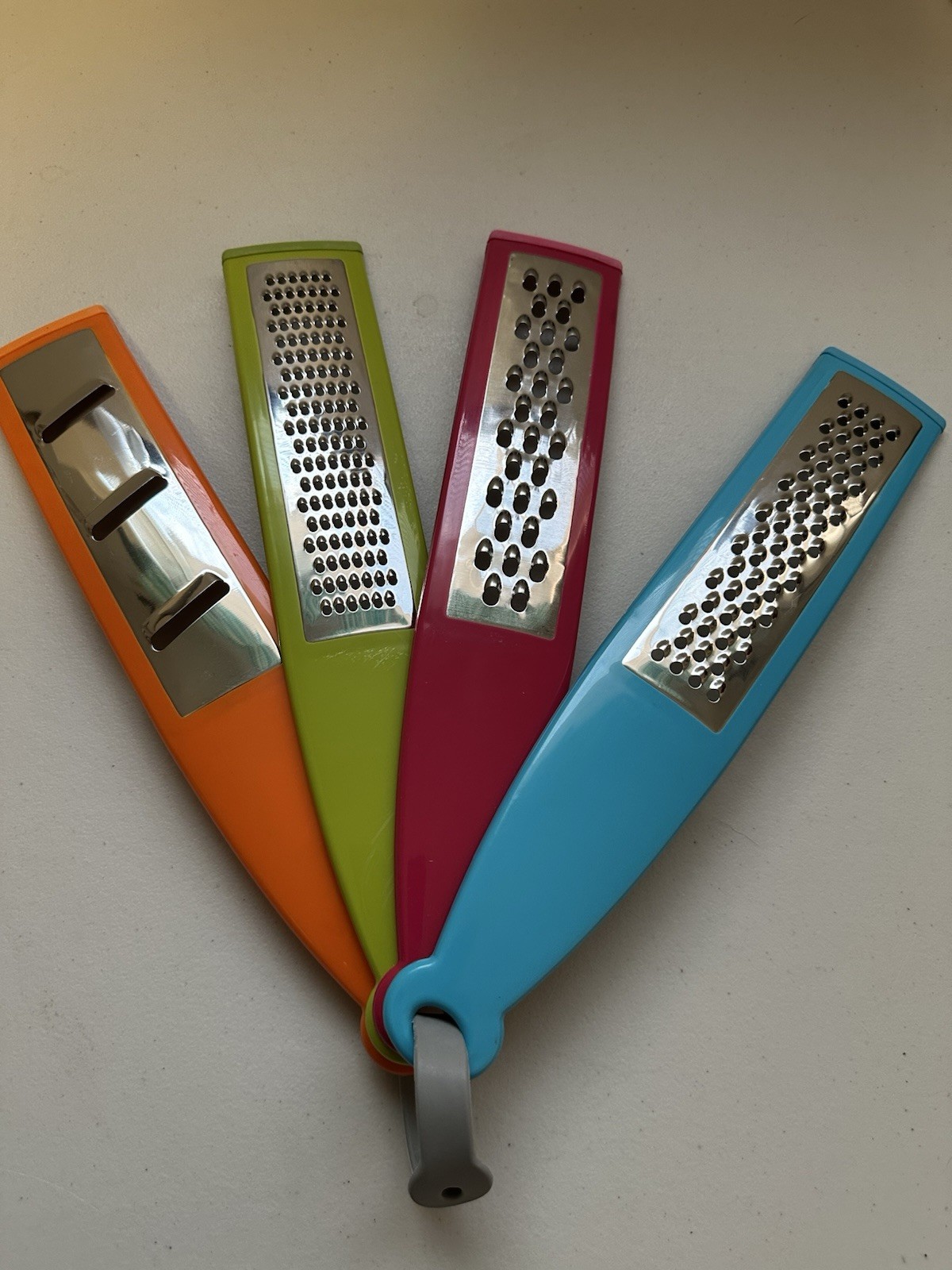 A Set Of Four Multi-colored Shredders