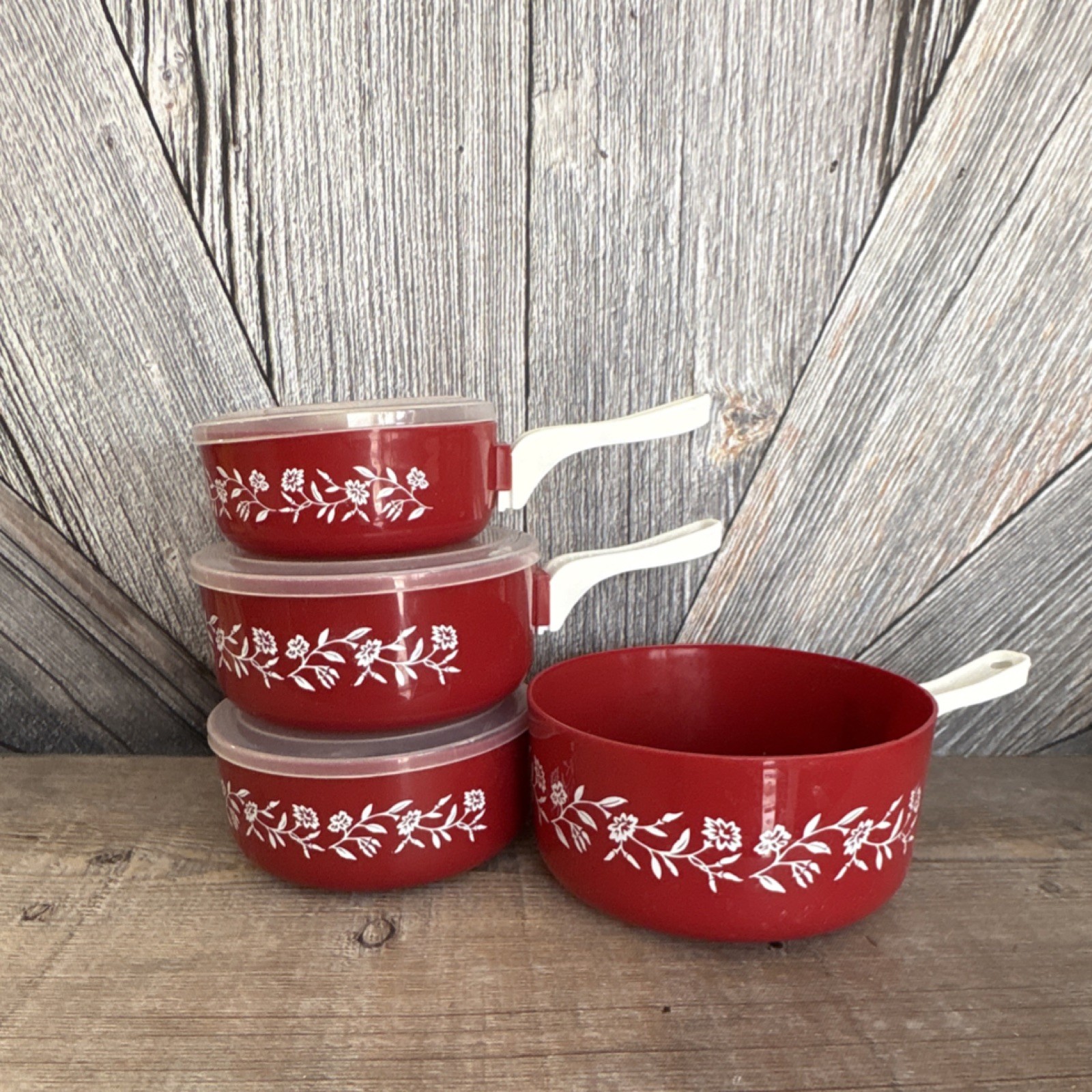 Red Floral Plastic Four-Piece Saucepan Set with Lids and White Handles