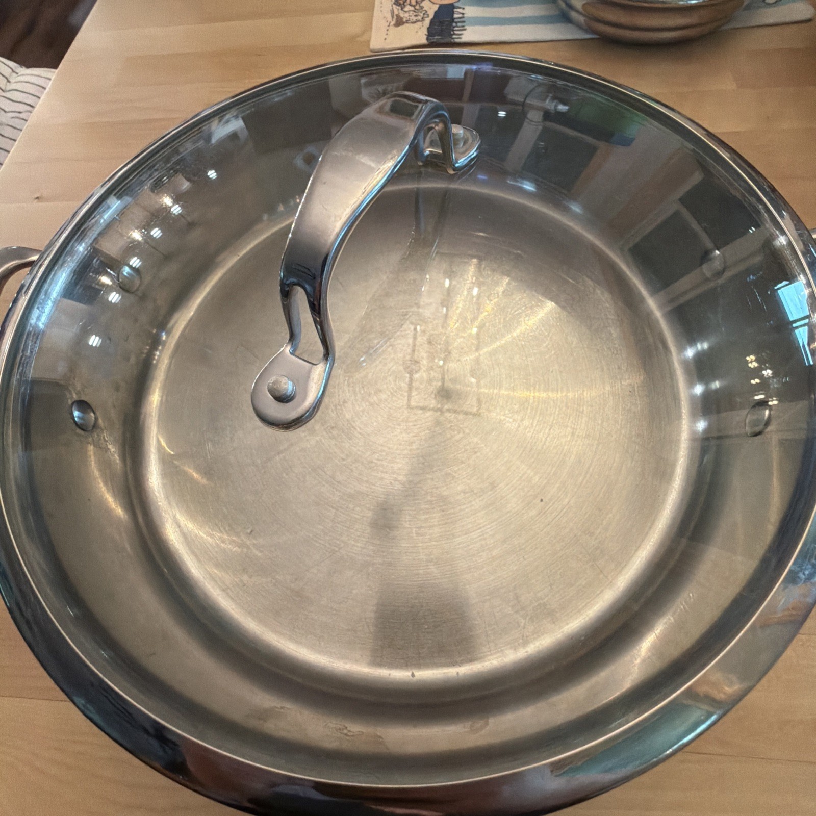 6.5 Qt. Braiser, featuring a large, stainless steel body with rounded sides.