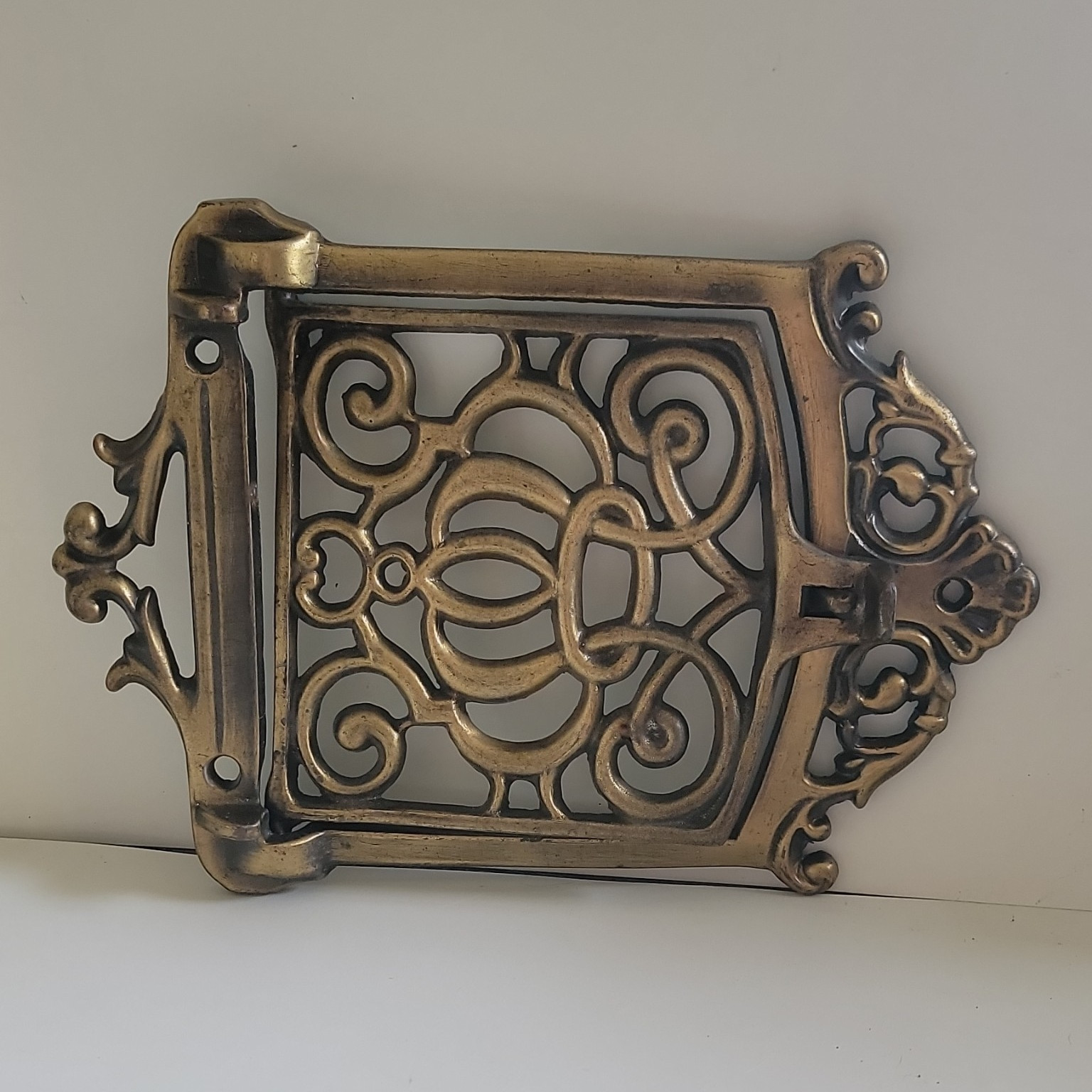 This antic ornate brass speakeasy door grille, wood-burning cookstove.